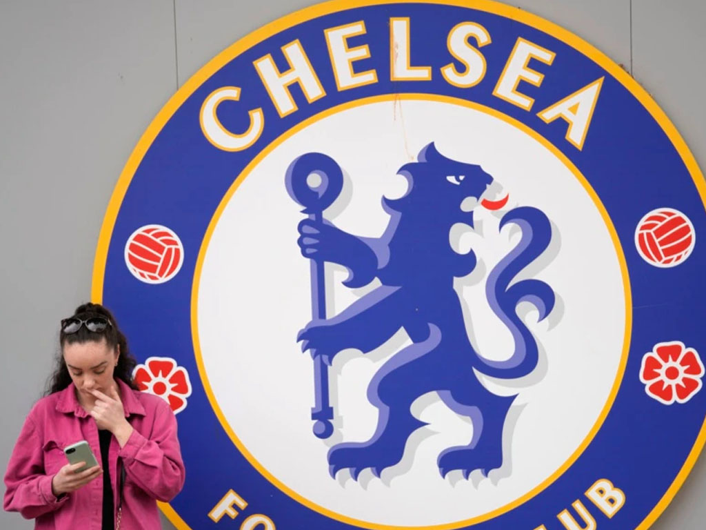 perempuan di depan logo chelsea