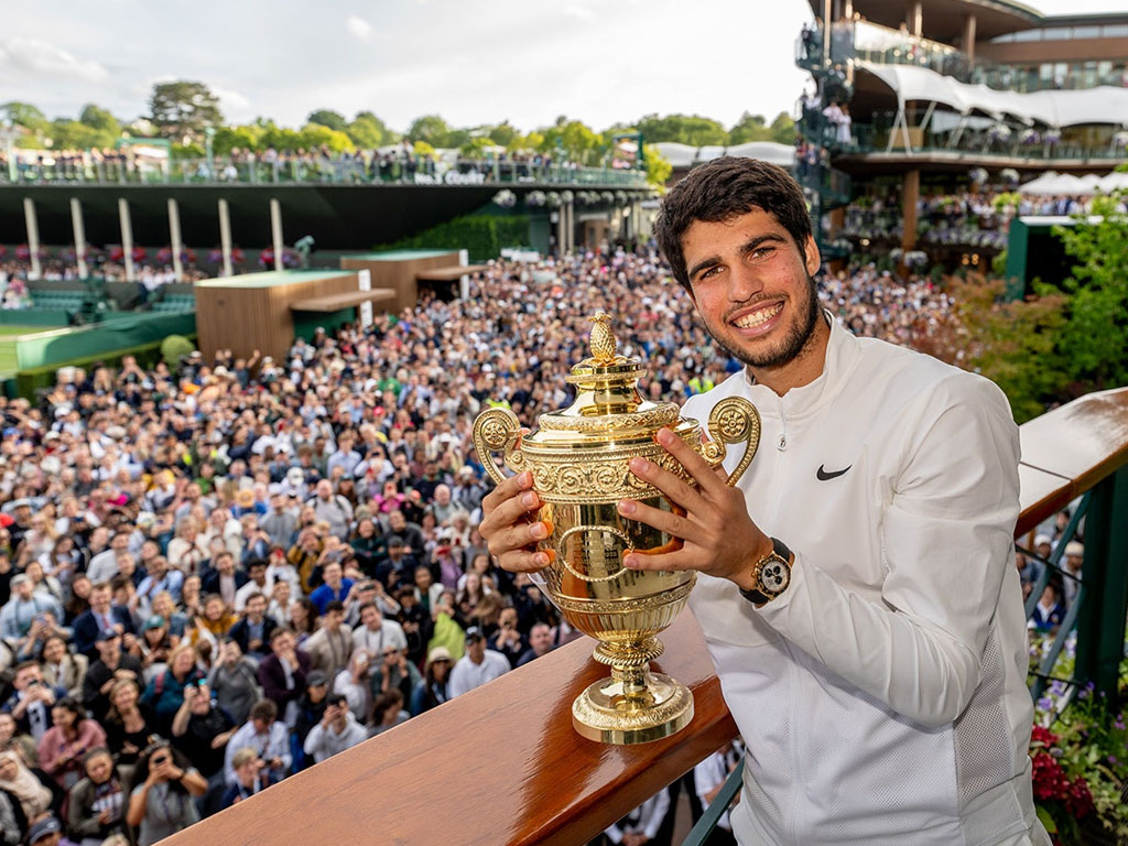 alcaraz pegang trofi wimbledon 2023
